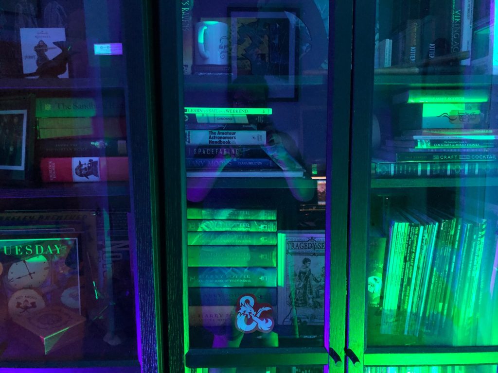 Bookcases illuminated by purple and green LED lights...