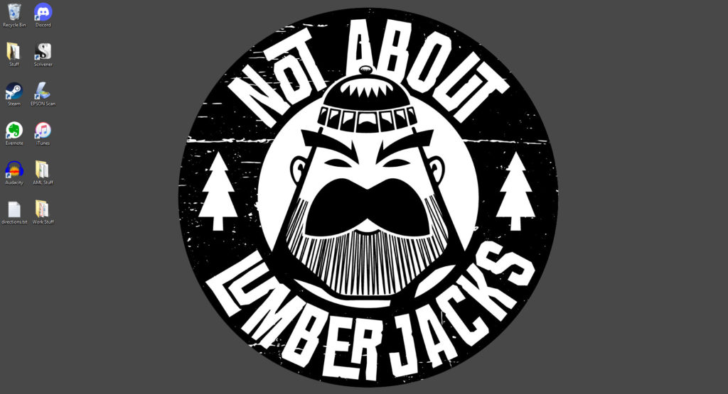 Computer desktop. Image: Various software shortcuts display on the left side of the screen. The Not About Lumberjacks logo displays in the middle against a gray back ground.

Logo design: A cartoon head of a serious-looking lumberjack. A circle around him reads Not About Lumberjacks in a quirky font. He is flanked by two icons of pine trees. 