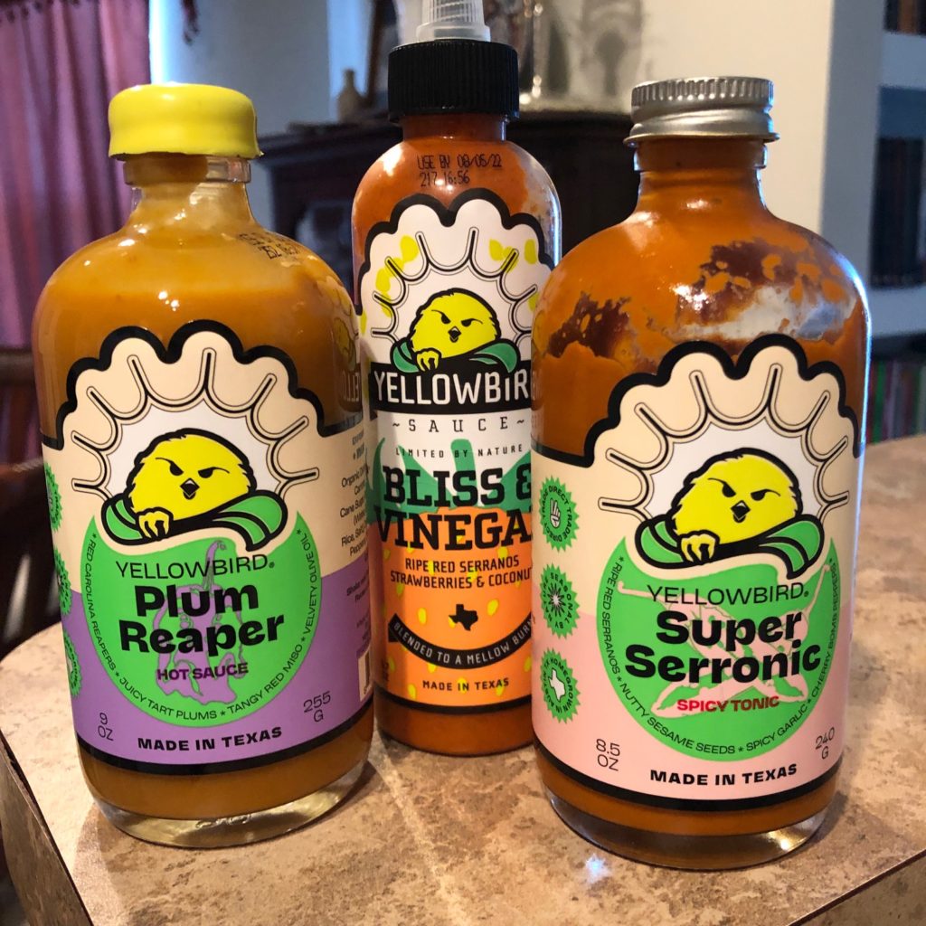 Hot sauce bottles: Yellowbird Plum Reaper, Bliss and Vinegar, and Super Serronic.